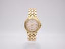 Front view of gold Raymond Weil Tango watch with cream dial, Roman numerals, and date window.