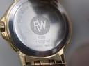 Close-up of the watch case back showing 'RW' logo, model 5360, serial Z 575742, 'stainless steel water resistant 5 ATM sapphire crystal swiss made'.