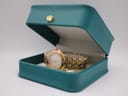 The Raymond Weil Tango watch presented open in a teal generic display box.