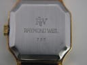 Close-up of the watch case back, engraved with 'RW', 'RAYMOND WEIL', and model number '737'.