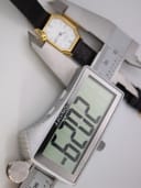 The watch being measured by a digital caliper, displaying a case size measurement of 22.3mm.