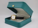 The Raymond Weil watch presented in a teal display box, showcasing its overall aesthetic.