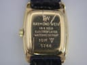 Close-up of the watch case back, revealing engravings including 'RW', 'RAYMOND WEIL', '18 K GOLD ELECTROPLATED', 'WATERRESISTANT', '10 M', and '5744'.