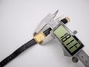 A digital caliper measuring the case diameter of the Raymond Weil 5744 watch, displaying a precise reading of 18.1mm.
