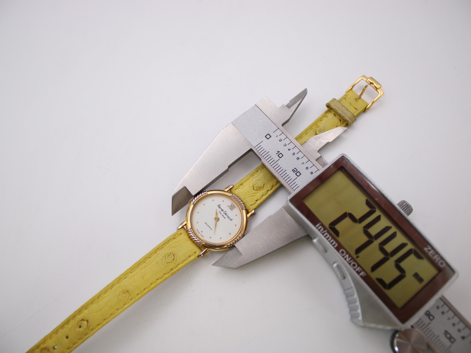 Digital caliper measuring the case diameter of the René Gérard watch, showing a precise reading of 24.45mm.