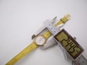 Digital caliper measuring the case diameter of the René Gérard watch, showing a precise reading of 24.45mm.