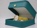 The René Gérard watch nestled inside a teal presentation box with a gold crown emblem on the lid.