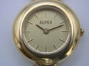 Macro shot of the Alfex gold dial, showing the logo, baton indices, hands, and "SWISS MADE" text.
