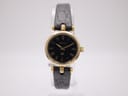 Front view of the Gucci 2000L ladies' watch, featuring a gold-tone case and a black dial with Roman numerals, paired with a black leather strap.