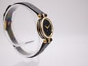 Another angled side view of the Gucci 2000L watch on a display stand, showing the elegant profile of the gold-tone case.