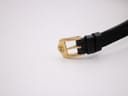 Close-up of the gold-tone buckle, clearly showing the embossed Gucci logo.