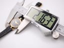 Close-up photo of a digital caliper measuring the watch case diameter, displaying an exact measurement of 21.63mm.