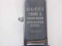 Close-up of the watch case back, engraved with "GUCCI 1500 L", "SWISS MADE", "STAINLESS STEEL", and the serial number "1361827".
