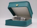 The Gucci 1500 L watch resting inside an open green presentation box with a gold crown emblem.