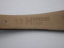 Close-up of the underside of the watch strap, showing the embossed '13 HIRSCH Lizard' marking, indicating lug width and material.