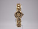 Front view of the gold-tone Bulova ladies' quartz watch with champagne dial and rhinestone-embellished bracelet on a clear stand.