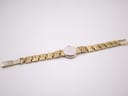 Back view of the Bulova watch, showing the plain stainless steel case back and the gold-tone bracelet with some wear on the underside.