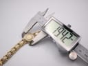 Close-up of a digital caliper measuring the Bulova watch case diameter at 19.42mm.
