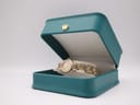 The Bulova ladies' watch displayed inside a small, open teal gift box with a gold crown emblem.