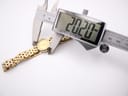 Digital caliper measuring the case diameter of the Raymond Weil watch, displaying a precise reading of 20.20mm.