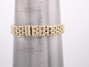 Close-up of the integrated gold-tone bracelet being measured on a wrist sizing cone, indicating a circumference of approximately 16.5cm or 165mm.