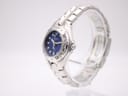 Side profile view of the Bulova Marine Star watch, showing the crown and integrated bracelet design on a clear stand.