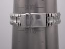 The watch bracelet clasped around a metal wrist sizing gauge, showing a wrist circumference reading of approximately 16.0cm (54mm diameter).