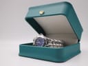 The Bulova Marine Star watch resting inside an open teal presentation box with a gold crown emblem on the lid, suggesting elegant display.