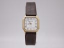 Front view of Tissot 21589 ladies' quartz watch with gold rectangular case, white roman numeral dial, and brown leather strap.