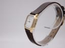 Side view of the Tissot 21589 gold-coloured case, showing the integrated hidden electronic crown.