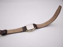 Close-up of the underside of the brown leather strap, showing 'GENUINE LEATHER' and 'Darlona' markings.