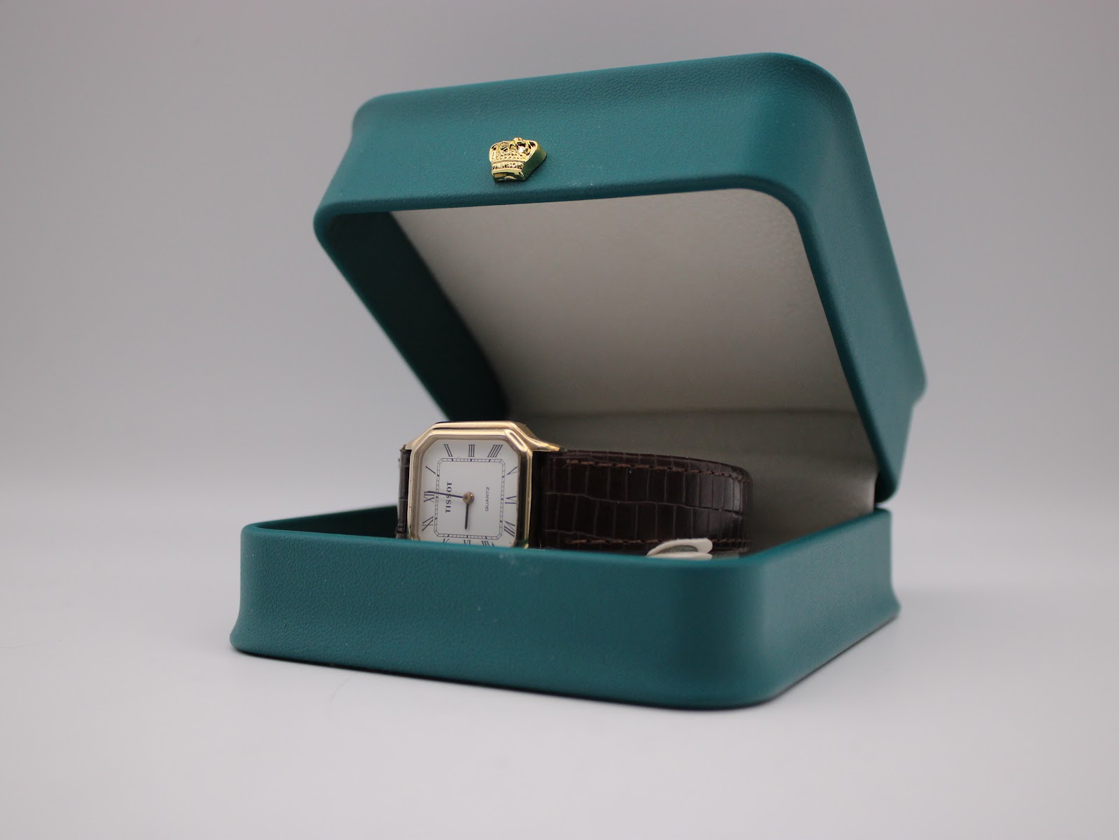 Tissot 21589 watch displayed in an open teal presentation box.