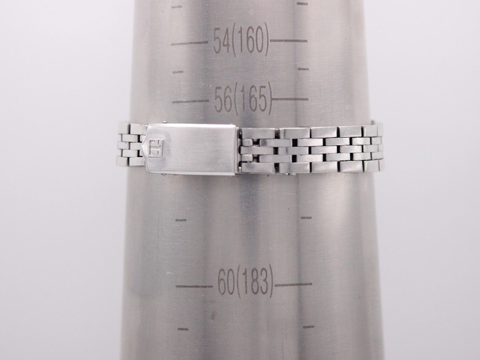 The Tissot PR 516 bracelet on a wrist sizing gauge, indicating a maximum wrist circumference of approximately 165mm.