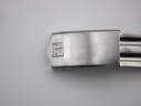 Close-up of the integrated bracelet's folding clasp, clearly showing the Tissot 'T' logo.
