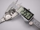 Digital caliper measuring the case diameter of the Tissot PR 516, displaying a precise measurement of 23.5mm.