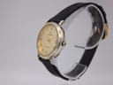 Side profile view of the Continental watch on a transparent display stand, showing the two-tone case and crown details.