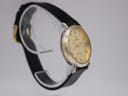 Angled side view of the Continental watch on a display stand, highlighting the polished two-tone case and the texture of the black leather strap.