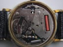 Close-up of the watch's Swiss quartz movement, showing the battery, circuit board, and internal mechanical components.