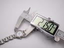 Top-down view of the Raymond Weil watch being measured by a digital caliper, displaying a case size of 21.50mm.