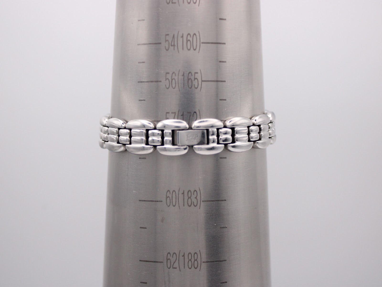 The Raymond Weil watch bracelet wrapped around a wrist sizing gauge, indicating a wrist circumference of 160mm (16cm).