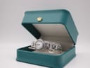 The Raymond Weil 5830 watch presented inside its original teal-coloured Raymond Weil box with a golden crown motif on the lid.