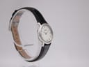 Opposite angled side view of the Tissot C226K watch on a transparent display stand, highlighting the case and strap.