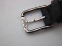 Detailed shot of the polished stainless steel buckle, clearly engraved with 'TISSOT'.