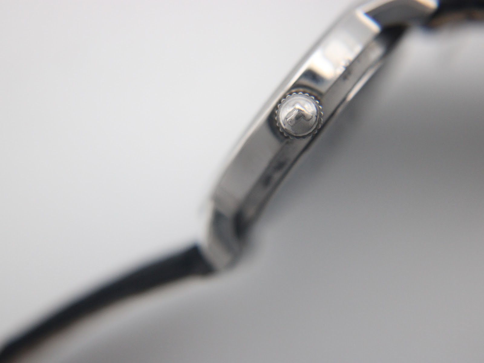 Close-up of the fluted crown on the side of the Tissot C226K watch case.