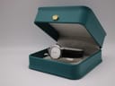 The Tissot C226K watch presented in an open teal display box, showcasing its elegance.