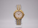 Front view of Bulova two-tone quartz watch with cream dial and gold-tone bezel on a white background.