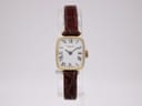Front view of Ingersoll ladies watch with white dial, Roman numerals, and brown leather strap on a clear display stand.