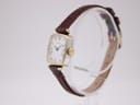 Angled side view of the vintage Ingersoll watch, showing the rectangular two-tone case and gold-tone crown.
