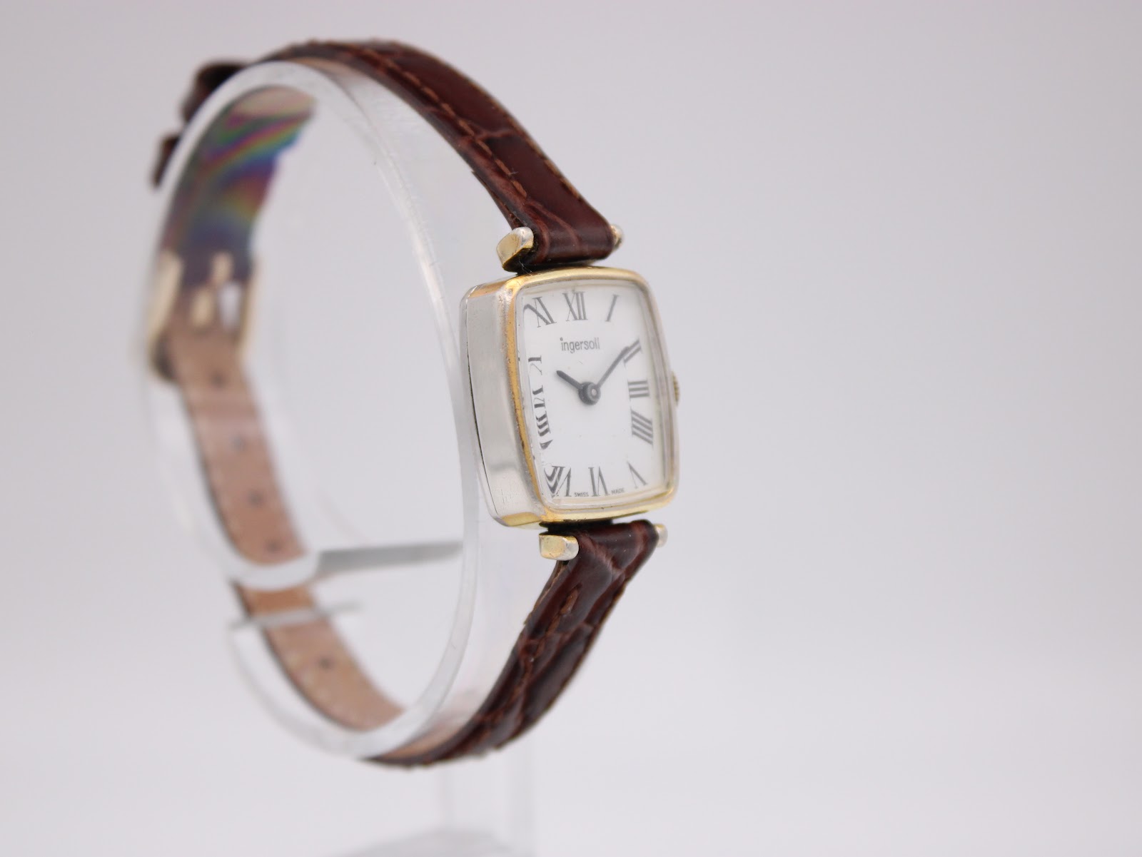 Another angled side view of the Ingersoll watch, highlighting the gold-tone bezel and silver-tone case sides.