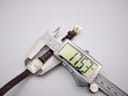 Digital caliper measuring the watch case width, displaying a precise measurement of 17.53mm.